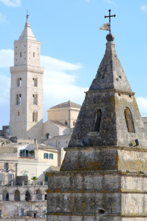 Costruzioni in tufo. Point of two bell towers and church in the ancient city of Matera in Italy. Construction with blocks of tufa stone. - MyVideoimage.com | Foto stock & Video footage