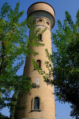 Cylindrical tower. Cylindrical brick tower soars into the blue sky. Stock photos. - MyVideoimage.com | Foto stock & Video footage