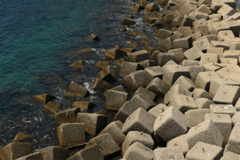 Dam on the sea with concrete blocks. An artificial reef for the protection of the coast in Forio d’Ischia near Naples. - MyVideoimage.com