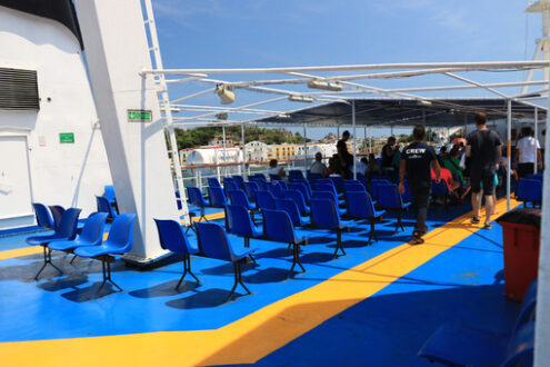 Deck of a ferry ship with crew and chairs. Blue and yellow color - MyVideoimage.com