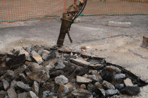 Demolition of the asphalt. Road construction site. Demolition of the asphalt of a road with a jackhammer. - MyVideoimage.com | Foto stock & Video footage