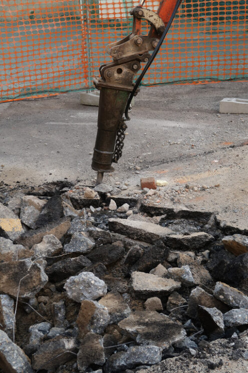 Demolizione asfalto in strada. Road construction site. Demolition of the asphalt of a road with a jackhammer. - MyVideoimage.com | Foto stock & Video footage