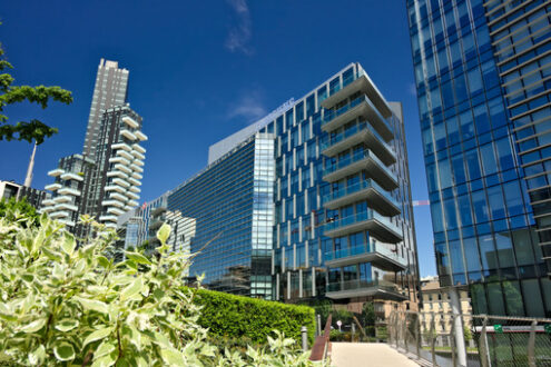 Edifici moderni a Milano. Solaria tower with balconies and modern buildings with curtan glass facades.  Business district with skyscrapers and glazed buildings. - MyVideoimage.com | Foto stock & Video footage