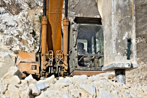 Excavator with demolition hammer in a Carrara marble quarry. A l - LEphotoart.com