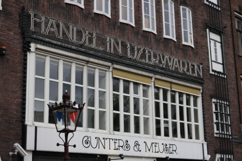 Facade of a building in the city center. Signboard and white win - MyVideoimage.com