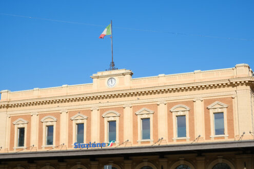 Facade of the Parma railway station. The Italian flag is placed on the building. - MyVideoimage.com