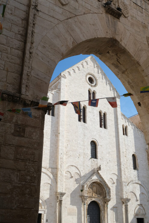 Façade of the church of San Nicola in Bari in limestone. Church with light stone walls with the blue sky background with clouds. Foto Bari photo.