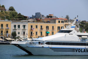 Ferry boat enters the port. The port of Ischia is housed in an ancient volcanic crater. - MyVideoimage.com