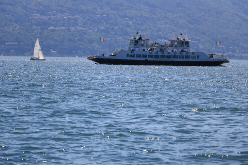 Ferry boat plows the waters of Lake Maggiore. In the background - MyVideoimage.com