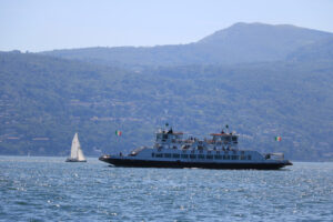 Ferry boat plows the waters of Lake Maggiore. In the background - MyVideoimage.com