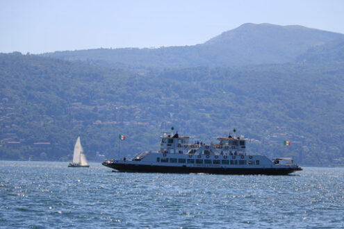 Ferry boat plows the waters of Lake Maggiore. In the background - MyVideoimage.com