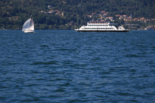 Ferry boat plows the waters of Lake Maggiore. In the background - MyVideoimage.com