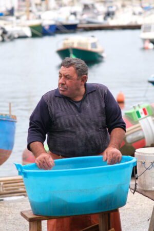 Fisherman at the port of Bari. At the market near the port the fishermen sell the fish caught. - MyVideoimage.com