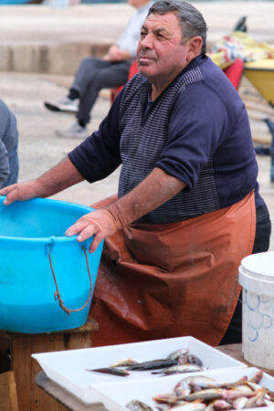 Fisherman at the port of Bari. At the market near the port the fishermen sell the fish caught. Foto Bari photo.