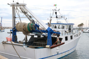 Fishing boat anchored at the pier of the Mediterranean port of Bari. - MyVideoimage.com