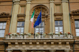 Flags on the balcony. Palace of the Prefecture of Alessandria. Stock photos. - MyVideoimage.com | Foto stock & Video footage