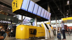 Flight info board at Amsterdam Schiphol airport. Help desk with display of aircraft departure times. - MyVideoimage.com