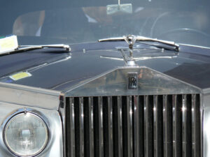 Front of a luxurious Rolls Royce car with a sculpture of a chromed metal angel. - MyVideoimage.com