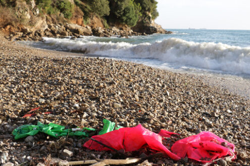 Garbage on the beach. Plastic waste deposited from the sea on the beach after the storm. Liguria, Italy. - MyVideoimage.com | Foto stock & Video footage