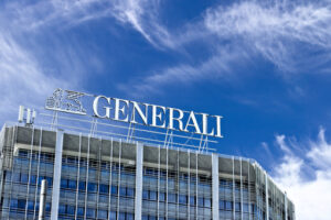 Generali Milano. Palazzo with Assicurazioni Generali sign in Milan.  The blue sky is the background of the Italian insurance company. - MyVideoimage.com | Foto stock & Video footage