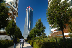 Generali tower Milan. CityLife Milan Residential Complex and Generali tower. Palaces designed by Zaha Hadid and surrounded by green gardens. Company building. - MyVideoimage.com | Foto stock & Video footage