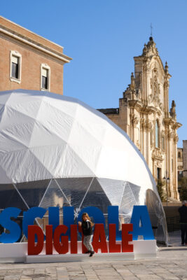 Geotechnical dome with a reticular structure for a digital school event organized by the Italian Ministry of Education in Matera. Little girl playing. - LEphotoart.com