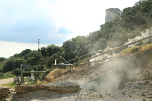 Geothermal energy with fumaroles and steam pipes. Geothermal power station. Condensation towers. Larderello. - MyVideoimage.com | Foto stock & Video footage