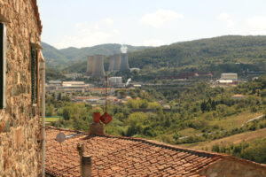 Geothermal power plant for electricity production. Condensation towers in reinforced concrete. A ancient stone farmhouse. Larderello, Tuscany, - MyVideoimage.com