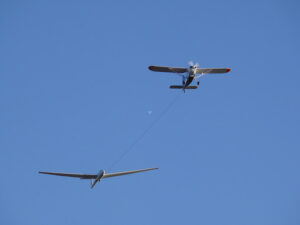 Glider pulled by a motorized plane. Glider airplane stands out f - MyVideoimage.com