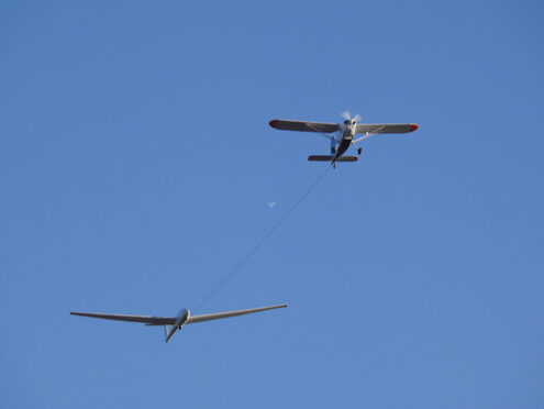 Glider pulled by a motorized plane. Glider airplane stands out f - MyVideoimage.com