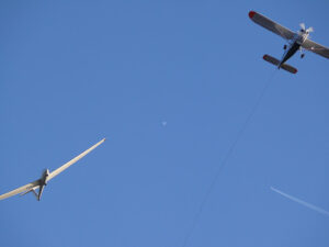 Glider pulled by a motorized plane. Glider airplane stands out f - MyVideoimage.com