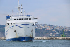 Golfo di Napoli. Ferry boat in the Gulf of Naples. In the background, the seaside - MyVideoimage.com | Foto stock & Video footage