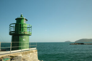 Green lighthouse. Lighthouse on the dike of the port of La Spezia.  Stock photos. - MyVideoimage.com | Foto stock & Video footage