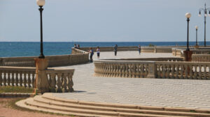 Group of people walking on the seafront of Livorno. The  Mascagni terrace is a famous place and meeting place for the citizens of the Tuscan city. - MyVideoimage.com