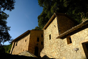 Hermitage of the Carceri of Assisi where St. Francis retired to pray. Made of light stone it is placed inside a forest. - MyVideoimage.com