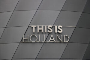 Holland signboard. This Is Holland stainless steel signboard. Gray aluminum facade. - MyVideoimage.com | Foto stock & Video footage