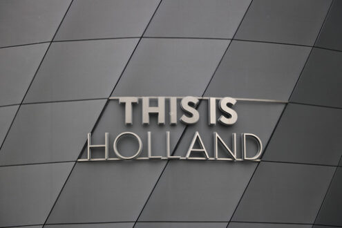 Holland signboard. This Is Holland stainless steel signboard. Gray aluminum facade. - MyVideoimage.com | Foto stock & Video footage