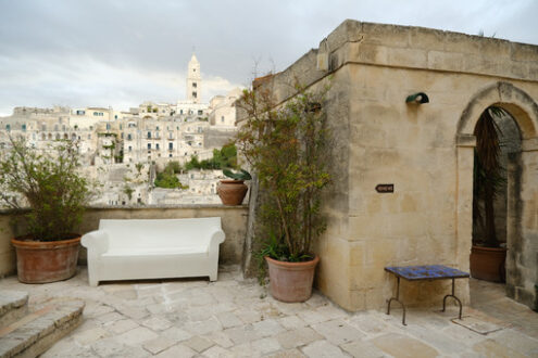 Hotel terrace in Matera. Hotel terrace and courtyard with sofas, chairs and tables overlooking the city of - MyVideoimage.com | Foto stock & Video footage