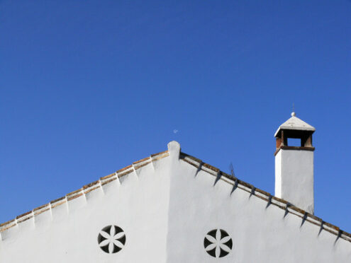 Facade decorations. House facade painted white.