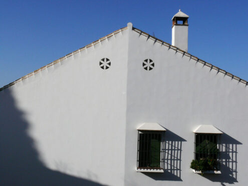 Ventilation holes. House facade painted white.