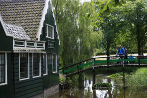 House on the stream. Wooden house on the stream. River bridge with people and childre - MyVideoimage.com | Foto stock & Video footage