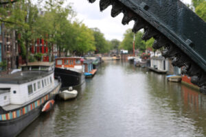 Houseboats and boats in an Amsterdam canal. Boats converted into - MyVideoimage.com