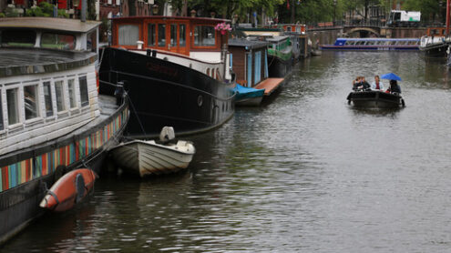 Houseboats and boats in an Amsterdam canal. Boats converted into - MyVideoimage.com