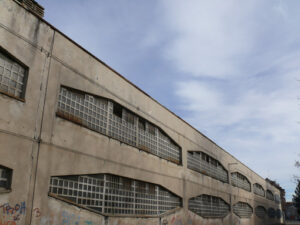 Industrial archeology buildings in the city of Busto Arsizio. Facade of an old factory with glass block windows. - MyVideoimage.com