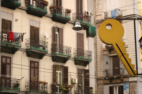 It teaches a large Yale-type key in the background of an apartment building facade. - MyVideoimage.com