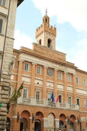 Italian palace in Foligno. Town Hall of Foligno with flags on the facade that move with the wind. - MyVideoimage.com | Foto stock & Video footage