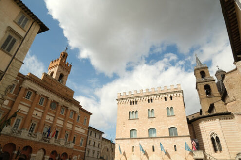 Italian square. Foligno. Piazza della Repubblica in Foligno with the town hall and canonics. The ancient palaces lit by the sun with cloudy sky. - MyVideoimage.com | Foto stock & Video footage