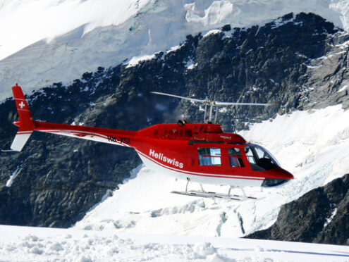 Jungfrau, Switzerlan, 08/06/2009. Red helicopter on high mountai - MyVideoimage.com