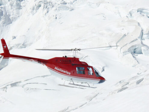 Jungfrau, Switzerlan, 08/06/2009. Red helicopter on high mountai - MyVideoimage.com