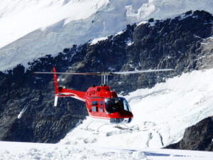 Jungfrau, Switzerlan. Red helicopter on high mountain snow - MyVideoimage.com